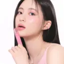 rom&nd Glasting Color Gloss held beside glossy pink lips