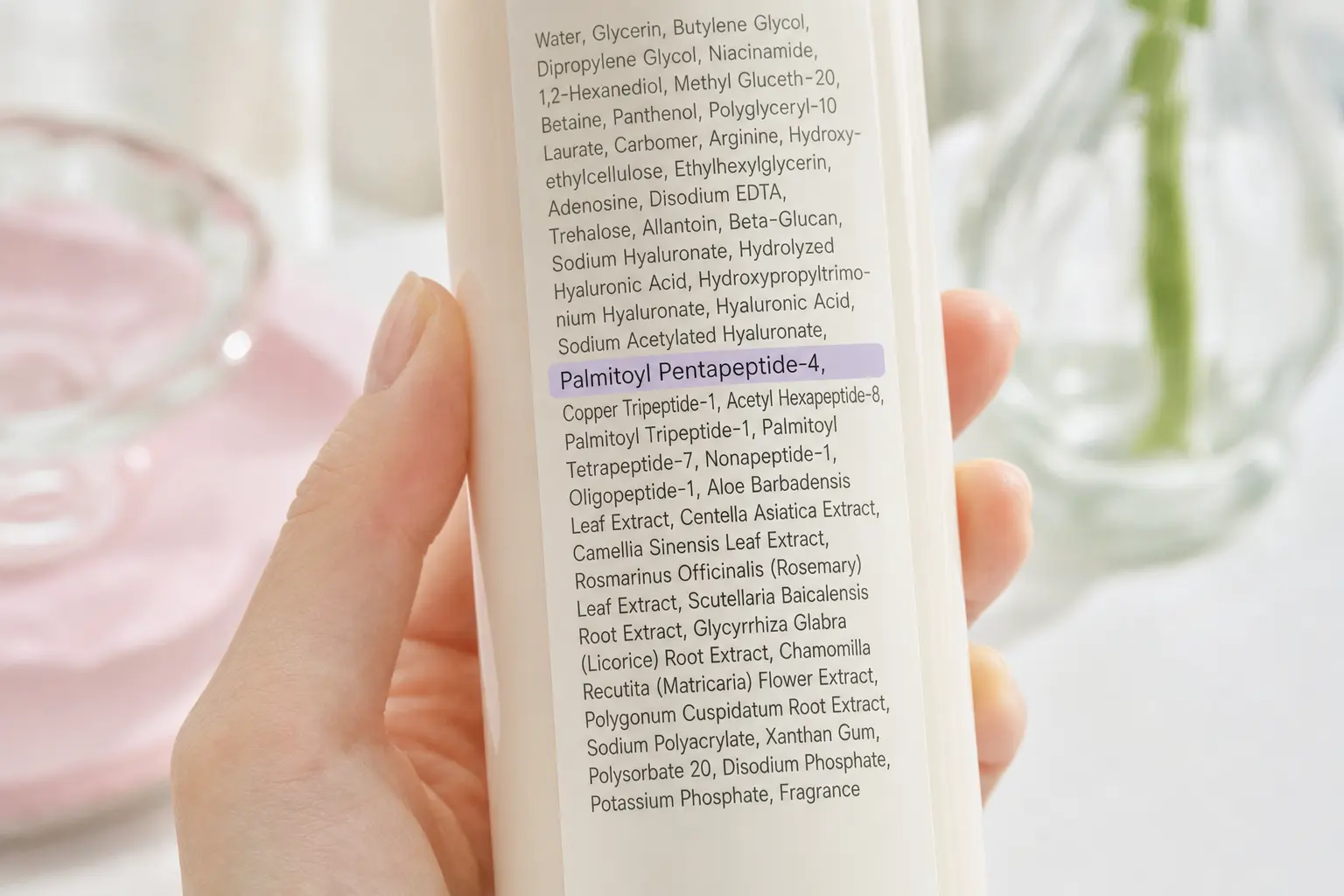 Macro shot of an ingredient label on a bottle showing detailed INCI lines, highlighting a line with 'palmitoyl pentapept